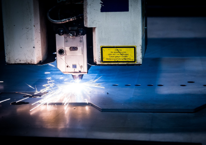 Photo of a lser cut machine sparking whilst cutting material